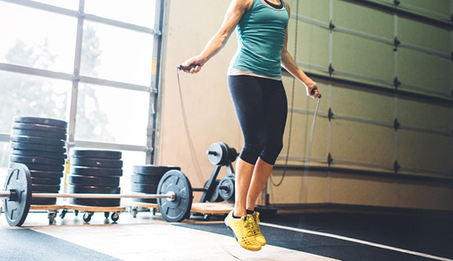 Woman jumping rope in gym